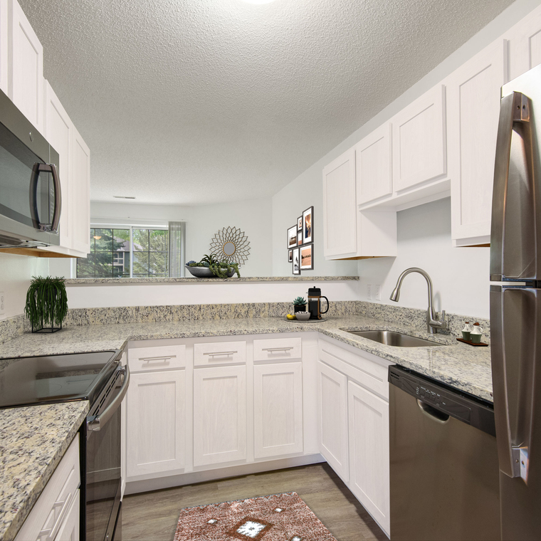 Granite counters, stainless steele appliances and white cabinets make this a dream space to cook in.